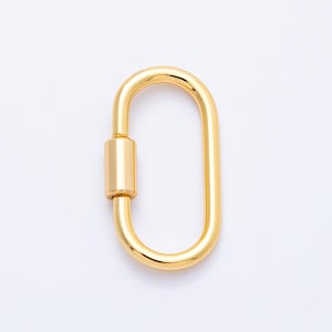 May include: A gold-colored oval carabiner clasp. The clasp has a screw-lock mechanism and a smooth, polished finish. The carabiner is a hardware component used for various applications, such as attaching items or securing straps.