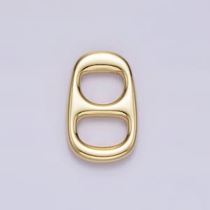 May include: Gold-colored metal ring with two loops, resembling a pull tab from a can.