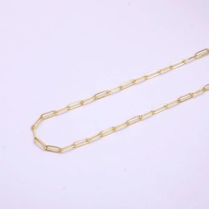 May include: A gold chain necklace with a simple, linked design. The chain is made of small, oval-shaped links.