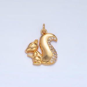 May include: A gold-tone squirrel pendant with clear crystal accents on the tail.
