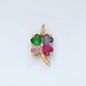 May include: Gold four-leaf clover charm with green, purple, pink, and red heart-shaped gemstones.