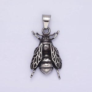 May include: A silver bee pendant with detailed wings and a textured body. The pendant has a loop at the top for attaching to a chain.