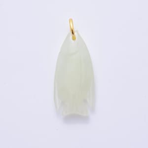 May include: A pale green pendant in the shape of a fish, with a gold-colored loop at the top. The fish pendant has a smooth, translucent appearance and is set against a white background. The pendant is a unique piece of jewelry.