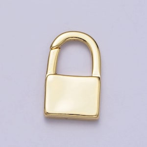May include: A gold-toned padlock charm with a smooth, shiny finish. The charm is shaped like a traditional padlock with a rounded top and a square body.