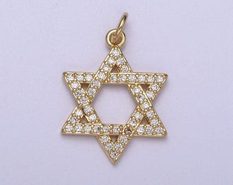 May include: A gold-toned pendant in the shape of a Star of David, with small clear stones set into the metal.