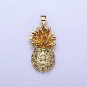 May include: A gold pineapple charm with clear and yellow rhinestones. The charm is a popular choice for jewelry making and is perfect for adding a touch of tropical flair to any piece.