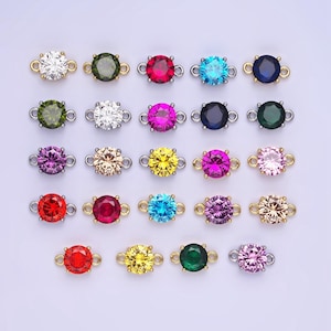 May include: Assortment of 24 round connector charms with various colored rhinestones. Each charm has a silver loop on either side.