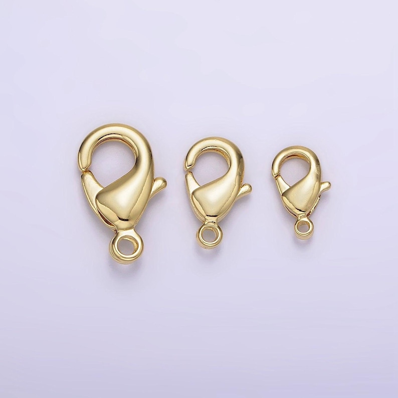 May include: Three gold-toned lobster clasps of different sizes. The clasps are commonly used for jewellery making.