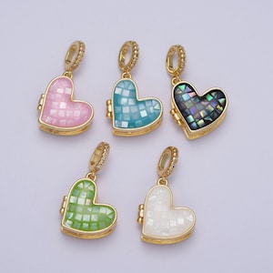 May include: Five gold heart-shaped charms with a mosaic design. The charms are in different colors: pink, blue, black, green, and white.