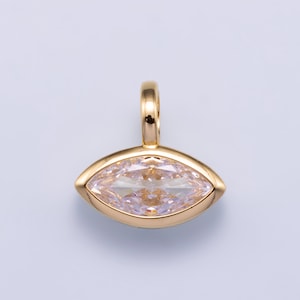 May include: A gold pendant featuring a marquise-cut, light pink gemstone set in a smooth, polished gold bezel. The pendant includes a small, rounded gold bail at the top for attachment to a chain, showcasing a clean and symmetrical design.
