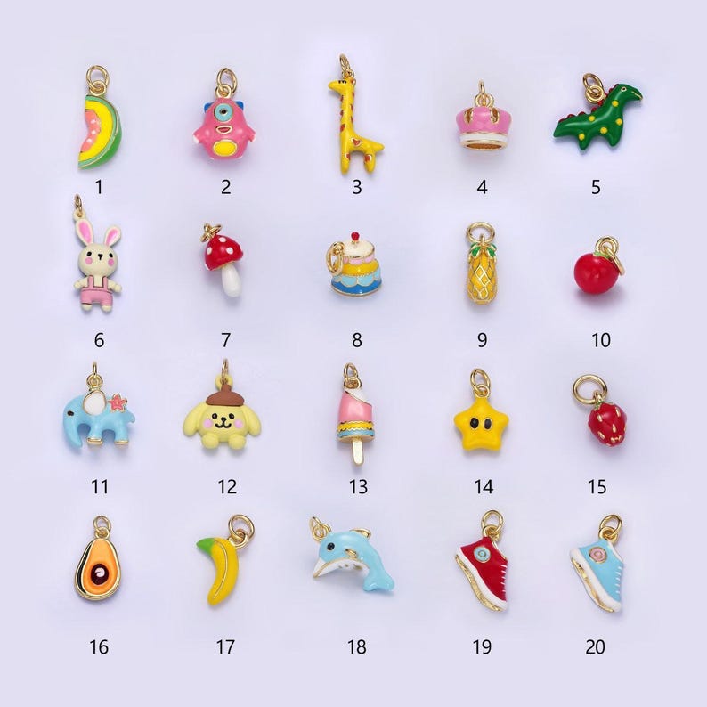 May include: Twenty colorful enamel charms with gold-tone jump rings. The charms include a watermelon slice, a monster, a giraffe, a crown, a dinosaur, a bunny, a mushroom, a cake, a pineapple, an apple, an elephant, a puppy, a popsicle, a star, a strawberry, an avocado, a banana, a dolphin, a red sneaker, and a blue sneaker.