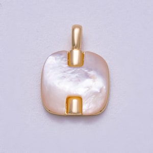 May include: A gold-colored pendant with a square, rounded shape and a pearlescent, off-white center. The pendant has a loop at the top and a smaller loop at the bottom, both in gold. The pendant is likely for a necklace or bracelet.