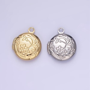 May include: Two round silver locket pendants with a floral design. One locket is gold and the other is silver.
