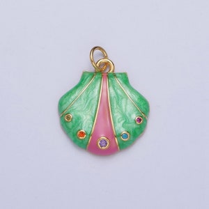 May include: A gold-tone pendant shaped like a seashell with green and pink enamel and colorful rhinestones.