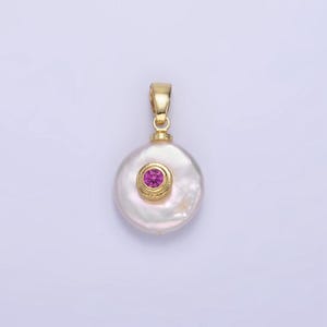 May include: A gold pendant featuring a white pearl with a pink gemstone set in a gold bezel.
