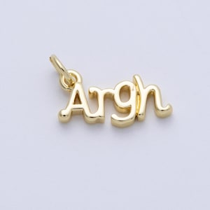 May include: A gold-colored charm pendant with the word "Argh" in a cursive font. The charm has a small loop at the top for attaching to a necklace or bracelet. The background is a solid, light color.
