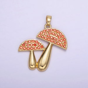 May include: Gold-tone pendant featuring two mushroom charms with red crystal accents.