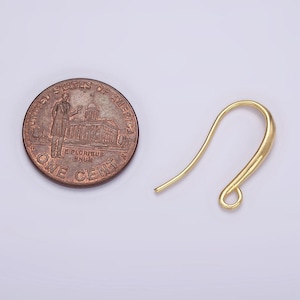 May include: Gold-toned earring hook with a loop at the bottom. The hook is about the size of a US penny.