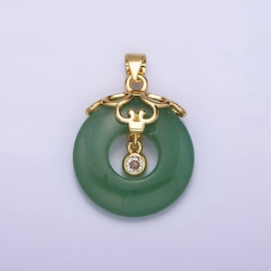 May include: A green jade pendant with a gold filigree design and a small clear crystal hanging from the center.
