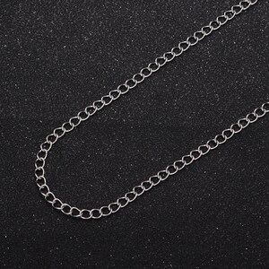 May include: A silver chain necklace with a simple, classic design. The chain is made of small, linked circles.