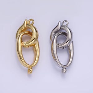 May include: Two metal clasps for jewelry making. One is gold and the other is silver.