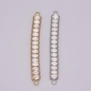 May include: Two silver and gold chain bracelet extenders with clear crystal accents. The extenders are made of metal and have a loop at each end.