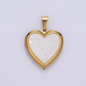May include: A gold heart-shaped locket with a white mother-of-pearl inlay.