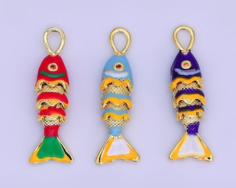 May include: Three colorful fish-shaped pendants with gold-tone accents. The pendants are red, blue, and purple, with yellow and gold details. Each has a loop at the top for hanging. The fish have layered scales and a detailed tail.