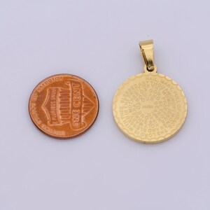 May include: Gold-toned metal pendant with a circular design featuring the Hail Mary prayer in English. The pendant is about the size of a US penny.