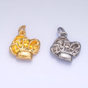 May include: Two chef hat charms, one gold and one silver, with a loop for attaching to a necklace or bracelet.