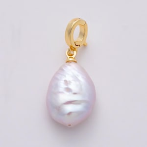 May include: A single gold-colored earring with a large, pear-shaped, iridescent pearl pendant. The pearl has a soft, pinkish-white hue with subtle surface textures. The earring's clasp is a simple, circular design.