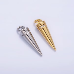 May include: Two silver and gold cone-shaped pendants with a row of clear rhinestones around the middle of each pendant.