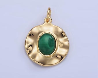 May include: Gold pendant with a green oval stone set in a textured circular frame.