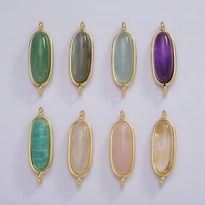 May include: Eight gold oval-shaped pendants with different coloured gemstones. The gemstones are green, grey, blue, purple, teal, white, pink, and yellow.