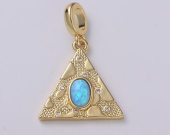 May include: Gold-colored pendant with a triangular shape and a loop at the top. The pendant features an oval, light blue stone in the center, surrounded by small, clear stones and a textured surface. A stylish piece of jewelry.