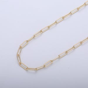 May include: A gold chain necklace with a simple, linked design. The chain is made of oval-shaped links.