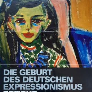 以下が含まれることがあります： ベルリンのブリュッケ美術館で開催される「Die Geburt des Deutschen Expressionismus Brücke」展のポスター。白黒のポスターに、女性の顔を描いたカラフルな絵画が掲載されている。