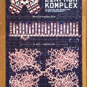 May include: A poster advertising an exhibition called "Einfach Komplex" at the Museum für Gestaltung Zürich. The poster features a black and white geometric design with red accents. The text on the poster reads "Einfach Komplex" and "Bildbräume und Baumbilder in der Wissenschaft". The dates of the exhibition are listed as "30. April - 4. September 2005".