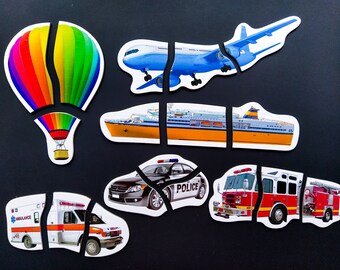 May include: A set of colorful puzzle pieces featuring different modes of transportation, including a hot air balloon, airplane, ferry, police car, ambulance, and fire truck.