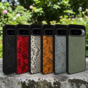 May include: Six smartphone cases arranged in a row, each featuring a distinct snakeskin-patterned back panel in black, red, white, orange, gray, and olive green. Each case has a black frame and a horizontal camera cutout at the top.
