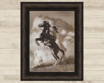 May include: A black and white photograph of a cowboy riding a rearing horse. The cowboy is holding a lasso in his right hand. The horse is in mid-air, with its front legs extended. The background is a cloudy sky.