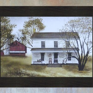 May include: A painting depicting a white farmhouse with a red barn in the background. The farmhouse features a porch with a rocking chair and a wreath on the door. The trees are bare and the sky is overcast.