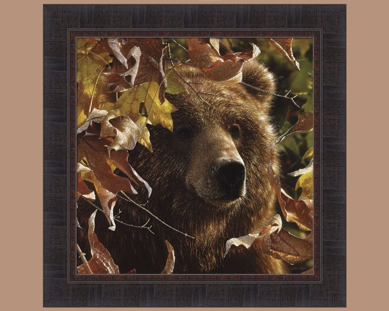 May include: A close-up of a brown bear's face peeking through a thicket of autumn leaves. The bear's fur is a rich brown, and its eyes are dark and intense. The leaves are a mix of red, orange, and yellow, and they create a beautiful contrast against the bear's fur.