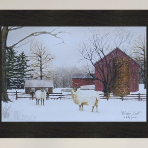 May include: A framed painting of a winter scene with two white sheep in a snowy field. A red barn with a brick chimney is in the background. The painting is titled "Winter Coat" by "Billy Jacobs".