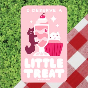 May include: Pink sticker featuring a cartoon illustration of a squirrel hugging a pink milkshake topped with a cherry. A pink cupcake with sprinkles sits beside the milkshake. The text "I deserve a little treat" is written in pink and white lettering. The text "KOOshiemart" is written in small white letters at the bottom.