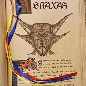 May include: An open book page featuring the word "BRAXAS" and a detailed illustration of a horned demon. Red, blue, and yellow ribbons are draped across the page. Text describes the demon Braxas and its history.
