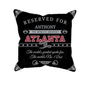 Puede incluir: Almohada decorativa en blanco y negro con el texto "Reservado para Anthony El mejor fan de Atlanta El mejor fanático del deporte del mundo. El papá número 1 del mundo"