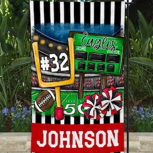 May include: A black and white striped garden flag with a red, white, and black football theme. The flag features a football goal post, a football, and cheerleaders' pom-poms. The text "Eagles" and "#32" are on the flag. The name "JOHNSON" is printed in white letters on a red background at the bottom of the flag.