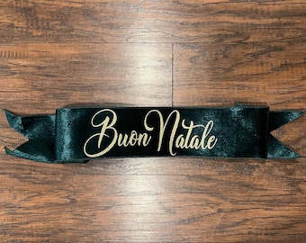 May include: A dark green velvet ribbon with gold glitter lettering that reads "Buon Natale".