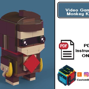 Puede incluir: Una minifigura Lego de mono marrón y beige que lleva un traje rojo y negro y una máscara negra para los ojos. La minifigura sostiene un plátano amarillo en cada mano. La imagen se titula "Videojuegos: Rey Mono" e incluye el texto "INSTRUCCIONES PDF ÚNICAMENTE".